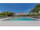 Community pool surrounded by lush landscaping and lounge chairs, perfect for relaxation and recreation at 6845 74Th Street E Cir, Bradenton, FL 34203