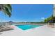 Inviting community pool with sun loungers offers a relaxing lakeside retreat under the sun at 6845 74Th Street E Cir, Bradenton, FL 34203