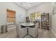 Cozy reading room featuring a round table with seating and bookshelves filled with books, creating a quiet retreat at 6845 74Th Street E Cir, Bradenton, FL 34203