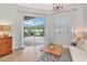 Sitting area with sliding glass doors leading to an outdoor lounge space with pavers and comfortable seating at 6845 74Th Street E Cir, Bradenton, FL 34203