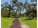 Scenic walking trail through lush greenery, ideal for a peaceful nature walk and exercise at 6845 74Th Street E Cir, Bradenton, FL 34203
