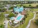 Aerial view of the community clubhouse with a pool and golf course at 7521 Aralia Way, Seminole, FL 33777