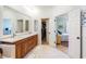 The bathroom features double sinks and a large mirror, with access to a walk-in closet at 7521 Aralia Way, Seminole, FL 33777