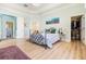 Primary bedroom with decorative rug, walk-in closet, and ensuite bathroom at 7521 Aralia Way, Seminole, FL 33777