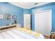 Bright bedroom featuring crown molding, light blue walls, white trim, and closet at 7521 Aralia Way, Seminole, FL 33777