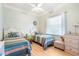 Charming bedroom with two twin beds, each adorned with striped comforters and decorative pillows at 7521 Aralia Way, Seminole, FL 33777