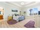 This bedroom features an iron bed frame, a large window, and an ensuite bathroom at 7521 Aralia Way, Seminole, FL 33777