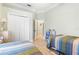 Shared bedroom featuring two twin beds, closet and doorway to other rooms at 7521 Aralia Way, Seminole, FL 33777