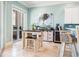Eat-in kitchen with tile floor, a breakfast table, modern appliances, and access to the patio at 7521 Aralia Way, Seminole, FL 33777