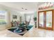 Formal dining area boasting unique light fixture and decorative front door at 7521 Aralia Way, Seminole, FL 33777