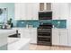 Modern kitchen featuring stainless steel appliances, stylish tile backsplash, and ample counter space at 7521 Aralia Way, Seminole, FL 33777