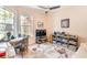 Home office with large window, neutral walls, and ceiling fan at 7521 Aralia Way, Seminole, FL 33777