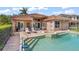 Relaxing backyard with a refreshing pool, hot tub, and plenty of lounge space at 7521 Aralia Way, Seminole, FL 33777