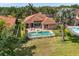 Aerial view of the backyard featuring a pool, spa, and manicured lawn at 7521 Aralia Way, Seminole, FL 33777