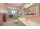 The bathroom offers a sink and tiled shower/tub behind a sliding door at 7604 Weeping Willow Cir, Sarasota, FL 34241