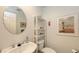 Well-lit bathroom with modern fixtures and a decorative mirror, enhancing the space at 7604 Weeping Willow Cir, Sarasota, FL 34241