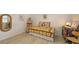 A bedroom with a rattan mirror, day bed and art on an easel at 7604 Weeping Willow Cir, Sarasota, FL 34241