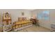 Cozy bedroom featuring a colorful daybed, an easel with art, and a window at 7604 Weeping Willow Cir, Sarasota, FL 34241