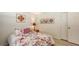 Cozy bedroom featuring floral bedding and artwork, complemented by a side table with a lamp at 7604 Weeping Willow Cir, Sarasota, FL 34241
