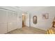 This bedroom features a closet, wood look flooring and a rattan mirror at 7604 Weeping Willow Cir, Sarasota, FL 34241