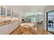 Cozy dining area with wood table and chairs connected to a bright living room and kitchen at 7604 Weeping Willow Cir, Sarasota, FL 34241