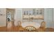 Bright dining area boasts wood floors, white table and chairs, and ample cabinet space at 7604 Weeping Willow Cir, Sarasota, FL 34241