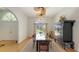 Dining room featuring a glass table with seating for six and hardwood floors at 7604 Weeping Willow Cir, Sarasota, FL 34241