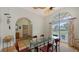 Bright dining room features a glass table, six chairs, and an arched entryway at 7604 Weeping Willow Cir, Sarasota, FL 34241