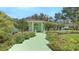 Charming home featuring a colorful entryway, lush landscaping, and a well-maintained front yard at 7604 Weeping Willow Cir, Sarasota, FL 34241