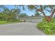 Large three-car garage with beautiful landscaping at 7604 Weeping Willow Cir, Sarasota, FL 34241