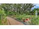 Scenic garden featuring a stone path and an assortment of lush plantings, shrubs, and ground cover offering a serene, natural landscape at 7604 Weeping Willow Cir, Sarasota, FL 34241