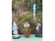 A tranquil garden featuring statues, garden sign and lush foliage creating a tranquil and serene outdoor oasis at 7604 Weeping Willow Cir, Sarasota, FL 34241