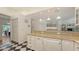 Open kitchen with granite countertops, checkered floors, and views of the dining area at 7604 Weeping Willow Cir, Sarasota, FL 34241