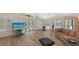 Bright living room featuring hardwood floors, a view of the pool, and lots of natural light at 7604 Weeping Willow Cir, Sarasota, FL 34241
