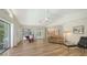 Bright living room boasts wood floors with easy access to the kitchen and screened outdoor pool at 7604 Weeping Willow Cir, Sarasota, FL 34241