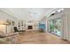 Inviting living room with built-in shelving, fireplace, and sliding doors opening to a lush yard at 7604 Weeping Willow Cir, Sarasota, FL 34241