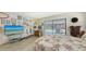 Spacious bedroom with pool access, wooden floors, and eclectic decor at 7604 Weeping Willow Cir, Sarasota, FL 34241