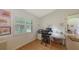 Cozy office space with natural light, wooden floors, and a view of the yard at 7604 Weeping Willow Cir, Sarasota, FL 34241