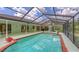 Spacious enclosed pool and patio area, with ample seating and lush landscaping in the background at 7604 Weeping Willow Cir, Sarasota, FL 34241