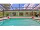 Tranquil enclosed pool and patio area, offering multiple seating areas and yard views at 7604 Weeping Willow Cir, Sarasota, FL 34241