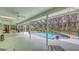 Inviting pool area offering a screened-in space, patio furniture, and lush greenery in the background at 7604 Weeping Willow Cir, Sarasota, FL 34241