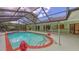 Wide shot of a pool with an enclosure, patio, and backyard at 7604 Weeping Willow Cir, Sarasota, FL 34241