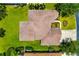 Overhead view of tiled roof, manicured lawn, and surrounding trees at 7727 Heyward Cir, University Park, FL 34201