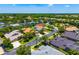 An aerial view showing a neighborhood with homes and tree-lined streets at 7727 Heyward Cir, University Park, FL 34201