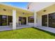 Covered outdoor patio with beautiful landscaping and manicured lawn at 7727 Heyward Cir, University Park, FL 34201
