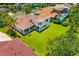 A well-maintained backyard with lush green lawn and mature trees offer privacy at 7727 Heyward Cir, University Park, FL 34201