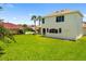 Backyard view features a well-maintained lawn and architectural details at 7727 Heyward Cir, University Park, FL 34201