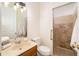 Bathroom with sink, toilet, and tiled walk-in shower with grab bar at 7727 Heyward Cir, University Park, FL 34201