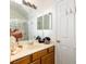 Bathroom vanity with decorations, large mirror, and shower stall at 7727 Heyward Cir, University Park, FL 34201