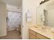 Bathroom with a large mirror, drawers, toilet, and tiled floors at 7727 Heyward Cir, University Park, FL 34201